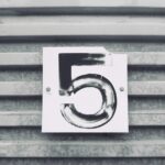 gray tile with white number five printed text